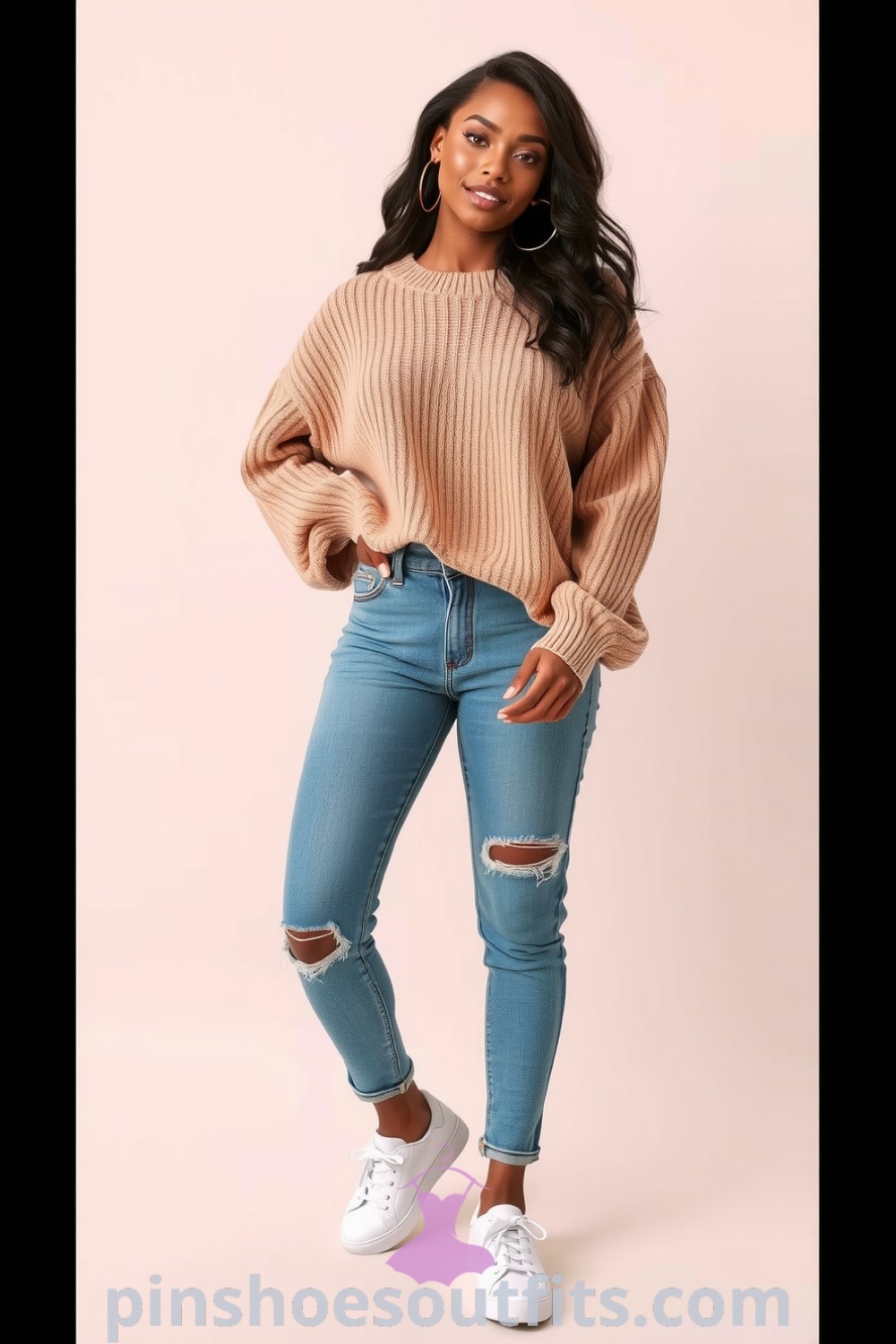 A Black woman wearing a relaxed casual outfit featuring a warm beige oversized knit sweater, distressed denim jeans, stylish white sneakers, and minimalistic hoop earrings. A representation of effortless comfort and modern elegance. pinshoesoutfits.com