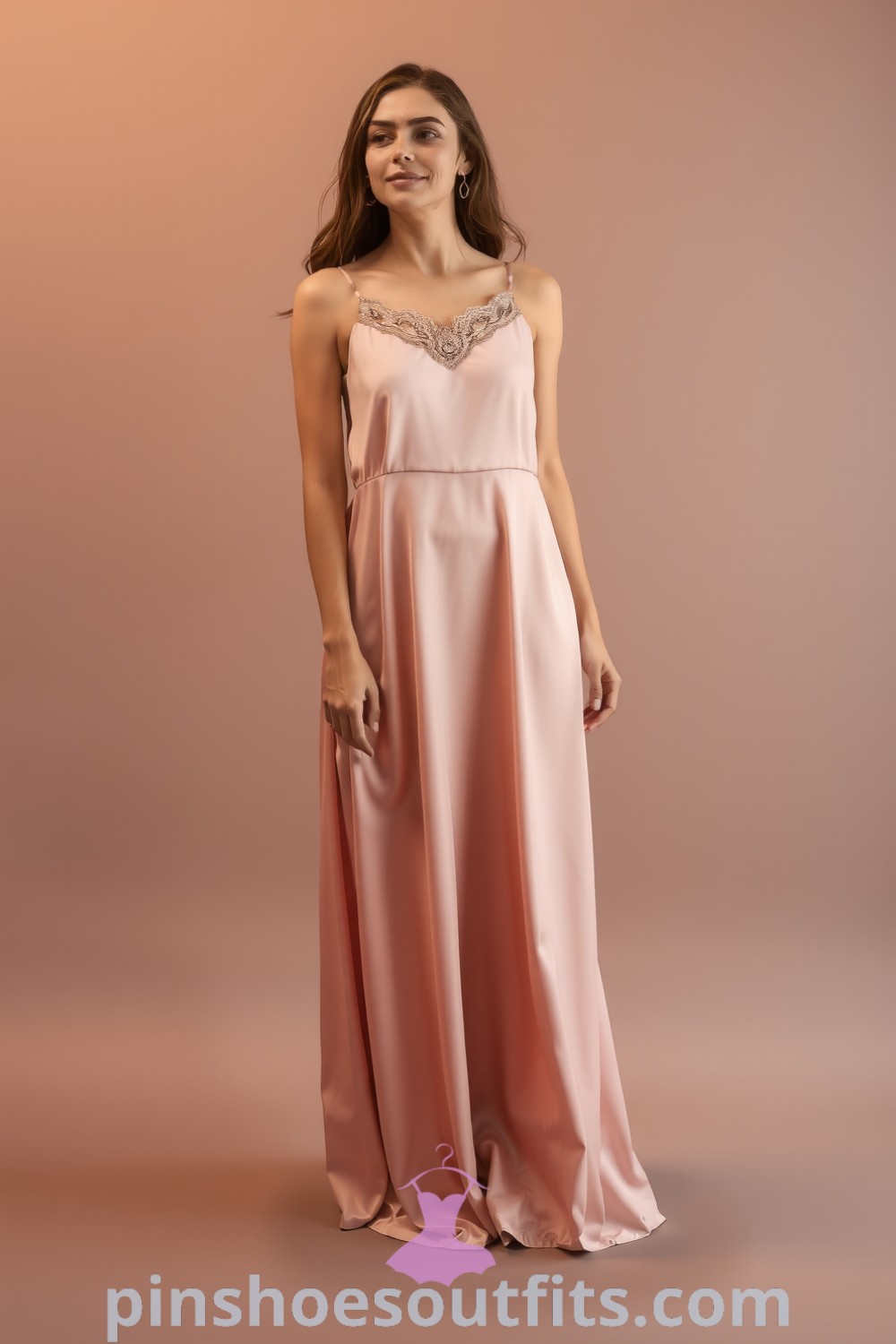 Elegant satin maxi dress with lace detailing, draping elegantly for a romantic date night. Features warm blush and gold hues, strappy heels, and understated earrings. Inspired fashion guide for classy outfits to look elegant. pinshoesoutfits.com