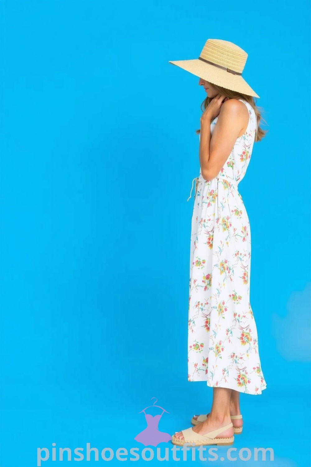 A woman in a floral sundress with an A-line silhouette, espadrilles, and a straw hat, embodying casual elegance and perfect for sunny outings. pinshoesoutfits.com